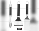 Essential Weber BBQ tools: a skewer, scraper, & spatula with black handles. Great for RV rental grilling.