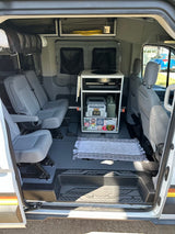RV rental interior: organized camper van with compact kitchen, flexible seating, and overhead storage for mobile living.