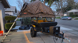 This overland trailer with a rooftop tent is perfect for camping adventures, offering a compact RV rental alternative.