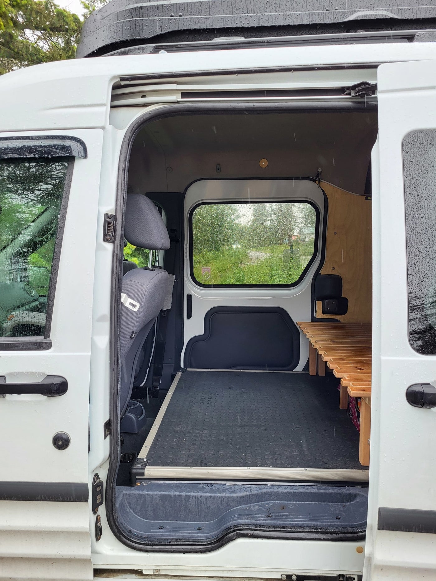  featuring a wooden slat bed/bench with a grey mattress & pillows. Ideal for an RV rental getaway — photo 11