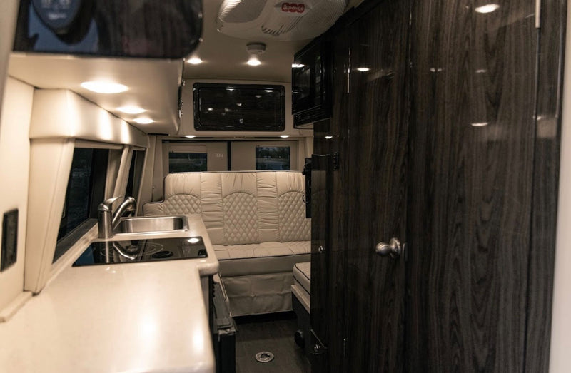  ready for your road trip comfort.|Step into this cozy RV rental interior! Features comfortable quilted seating — photo 16