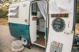 Explore 'Jemma the Jewel', a charming vintage RV rental. Enjoy its cozy interior and unique outdoor setup.