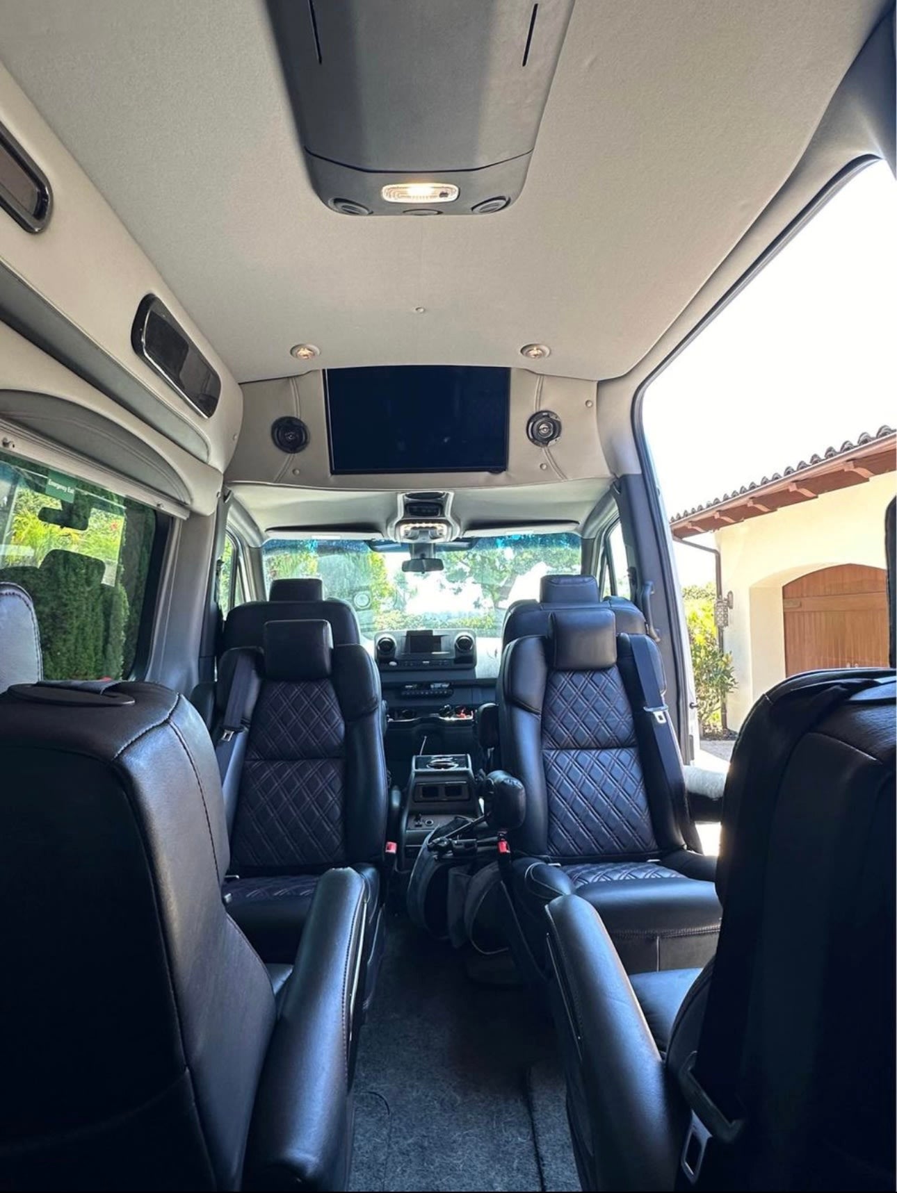  and a convertible rear bed for comfortable travel.|RV rental: View from the rear cargo area showing folded seats with storage nets — photo 3