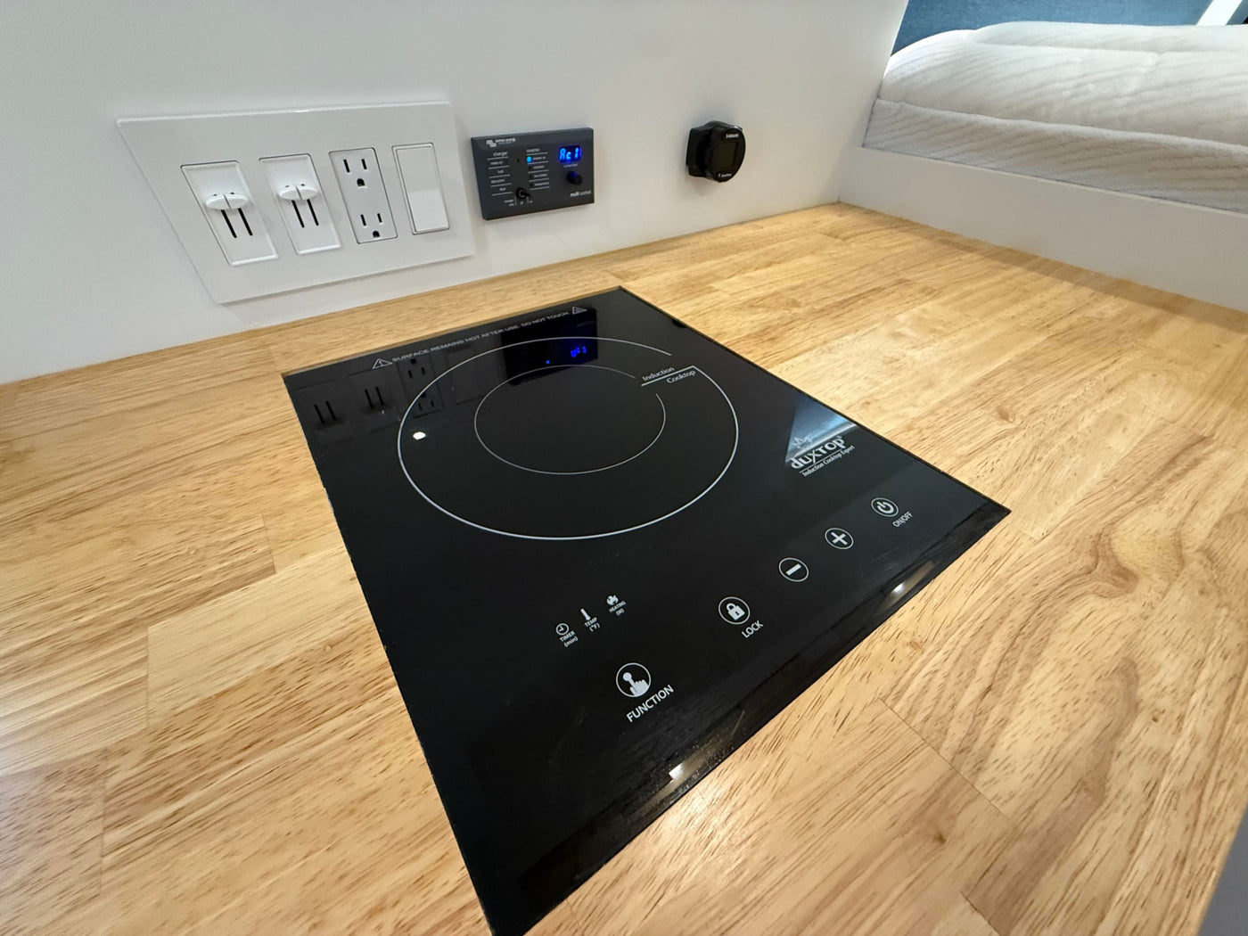  and elevated bed provide comfort.|RV rental interior with a compact kitchen — photo 10