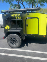 Rugged black and yellow Outbound T-Rex off-road camping trailer, ideal for an RV rental adventure.
