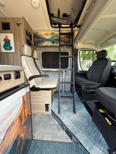 Dinette area with ladder to the pop-top area with a double bed. The table swivels out of the way to accommodate the ladder. 