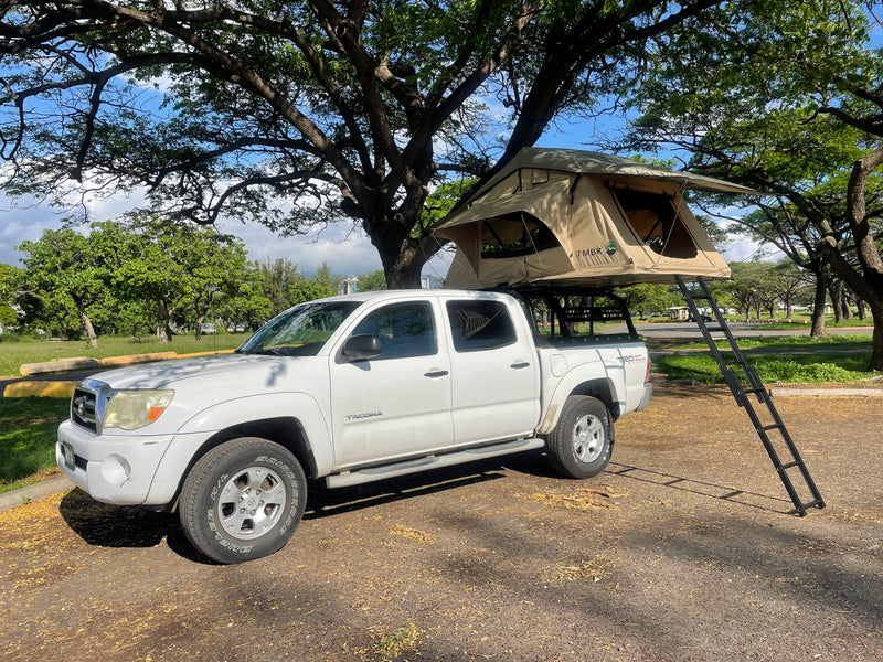 White Toyota Tacoma pickup with a deployed rooftop tent, perfect for an off-road camping RV rental adventure. — photo 2
