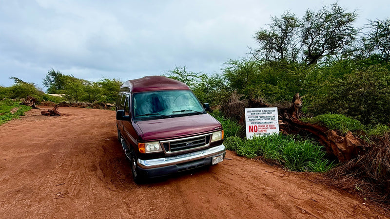  on sandy ground with tire tracks. Mountains backdrop.|RV rental's cozy interior: bed — photo 15