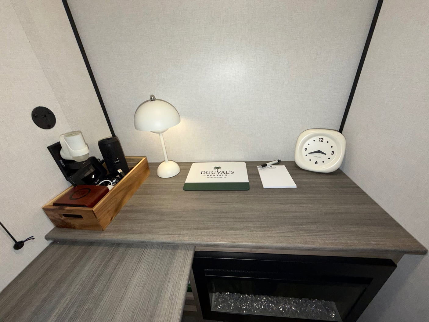  and a stylish black and white checkered shower.|This RV rental features a compact kitchen with a sink