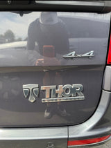 Rear of a dark gray Thor Motor Coach 4x4, reflecting the photographer. Great choice for an RV rental.