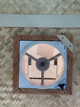 RV rental interior: A Maxx Fan on a woven ceiling with wood trim, enhancing ventilation for comfort.