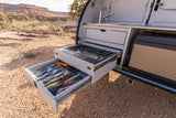 Explore the ultimate RV rental with this pull-out camping kitchen: stove, sink, and utensil drawers ready for outdoor cooking.