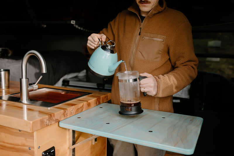 A traveler pours coffee in a cozy RV rental kitchen, perfect for on-the-go adventures. — photo 9