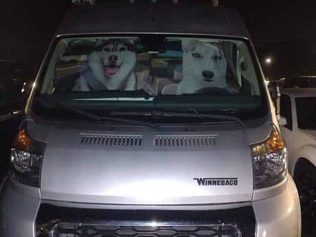 Hilarious dog sunshade featuring two huskies 'driving' a silver Winnebago rv rental van.