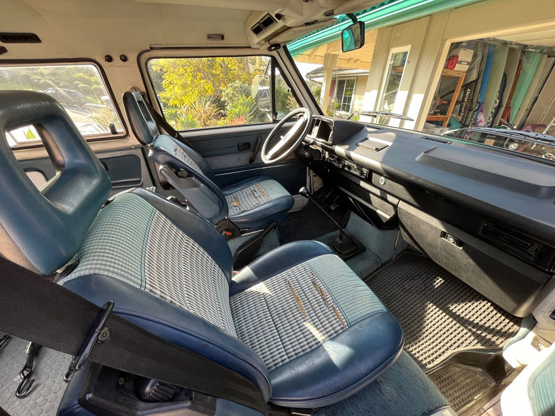 Inside a retro camper van, with blue and checkered seats & classic dash. Perfect for your next rv rental trip! — photo 6