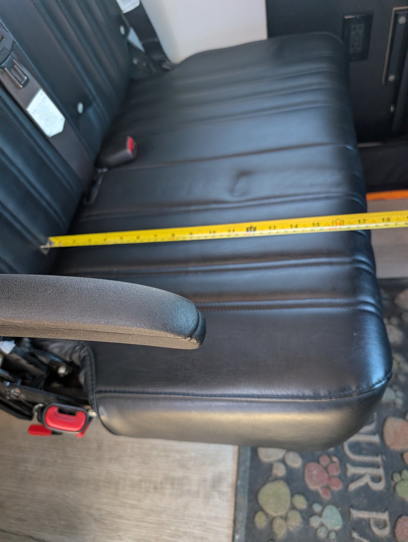 RV rental interior: Measuring the comfortable black padded seat width, showing about 18 inches across the cushion.