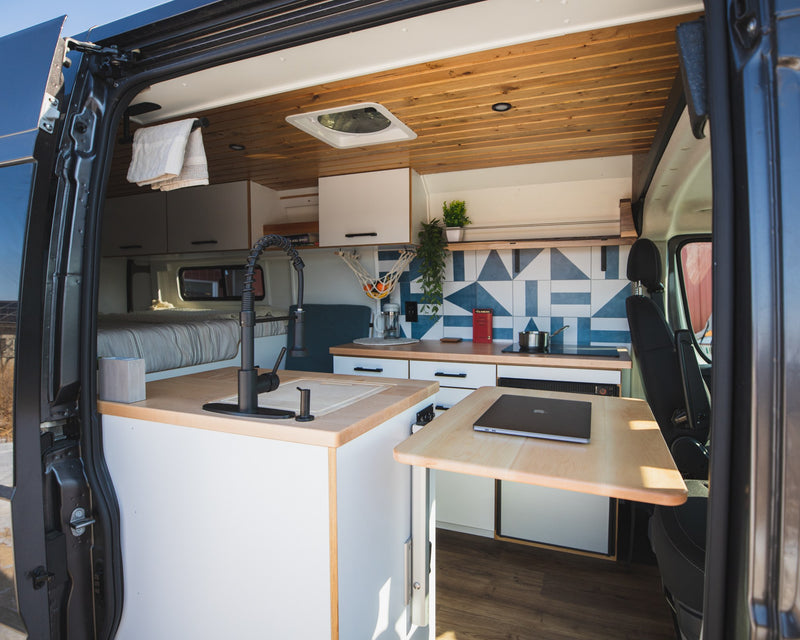  and smart overhead storage.|Detailed view of a modern RV rental kitchen. Features a black pull-down faucet — photo 6
