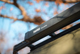 Thule Omnistor unit on vehicle roof, perfect for your RV rental. Durable outdoor gear.