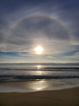 Stunning beach view with sun halo over the ocean. Perfect scenery for an RV rental adventure!