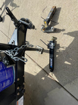 RV rental: Trailer hitch components, including a new ball mount and Reese weight distribution system, laid out on concrete.