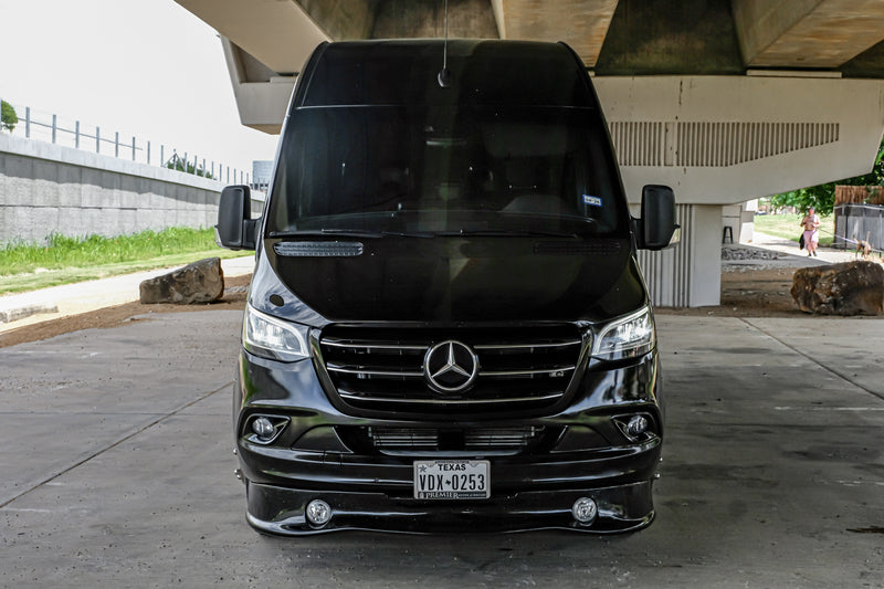 Black Mercedes Sprinter van, often used as an RV rental, parked under an overpass in Texas. — photo 2