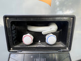 RV rental outdoor shower unit, featuring hot/cold water controls and a white wand, ideal for quick rinses.