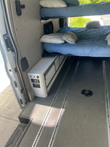 An RV rental's organized interior with bunk beds, Dometic fridge, and durable L-track floor.