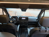 View inside an RV rental: modern Mercedes-Benz cockpit with dashboard, navigation, and front seats.