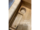 RV rental: Built-in wooden cup holder & phone rest, enhancing compact living.