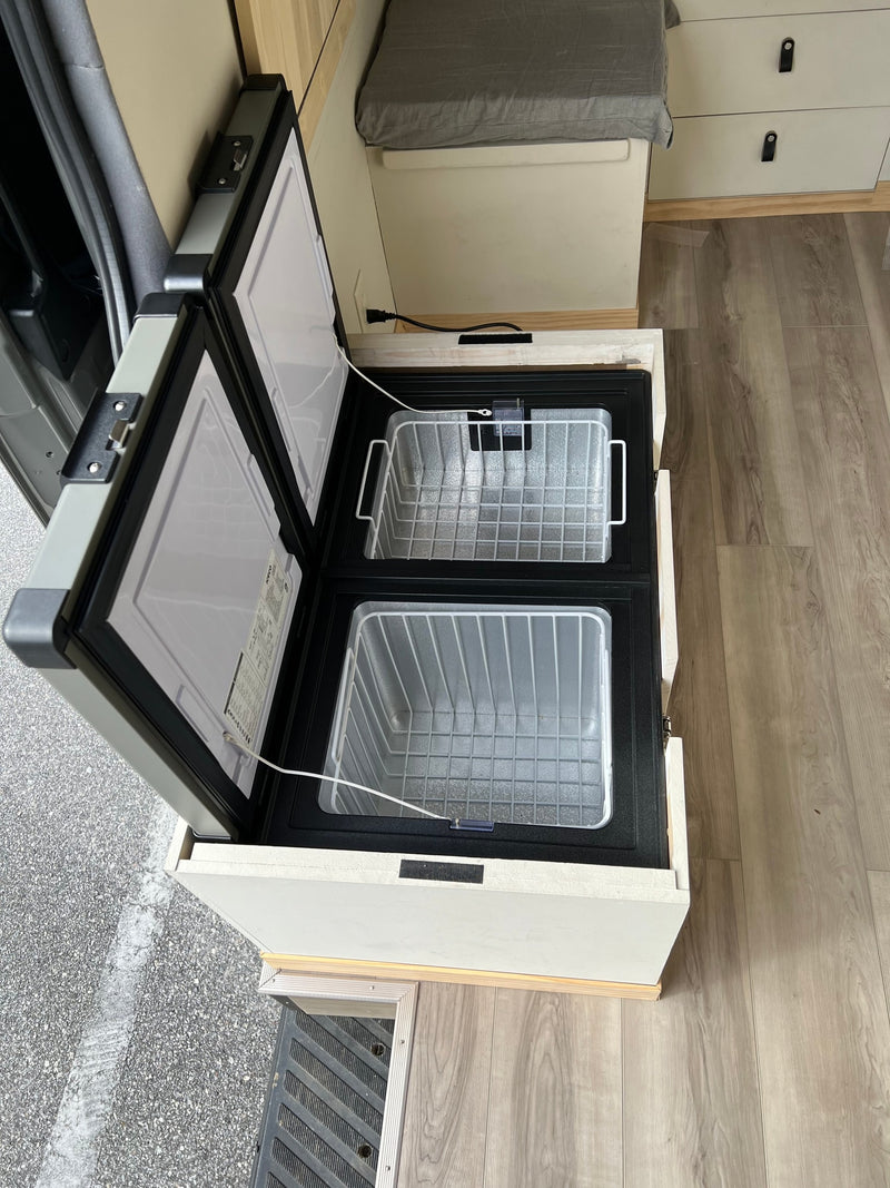 RV rental: Two chest-style fridges/freezers in a pull-out drawer, showing cold storage solutions inside a camper van. — photo 7