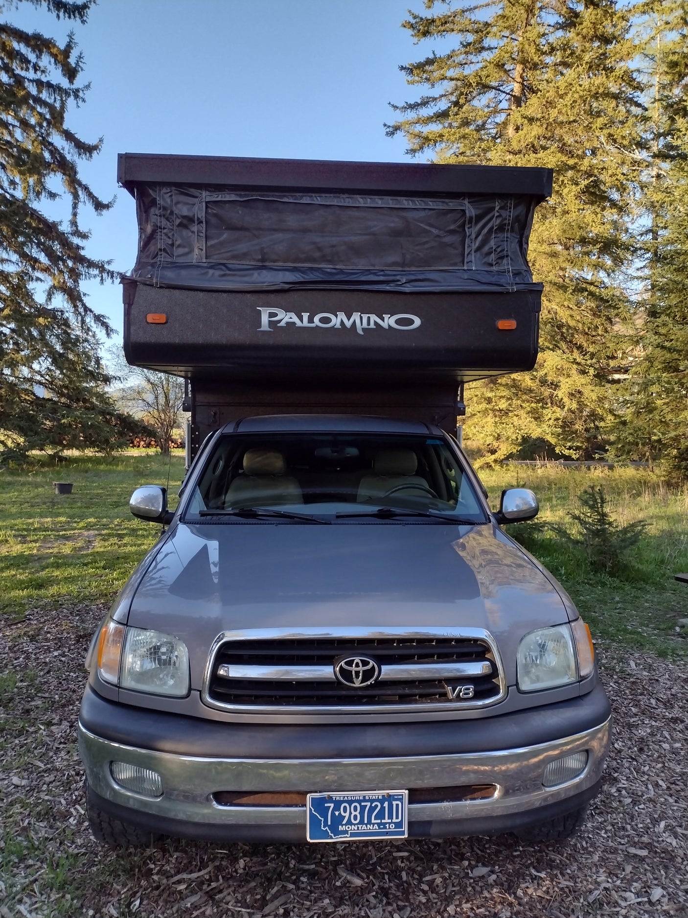 Grey Toyota Tundra with Palomino pop-up truck camper RV rental. Ready for outdoor adventures.
