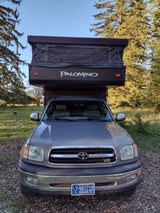 Grey Toyota Tundra with Palomino pop-up truck camper RV rental. Ready for outdoor adventures.