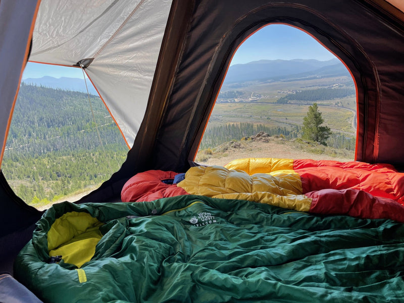 Inside a cozy **rv rental**, sleeping bags offer comfort with panoramic mountain and valley views. Ideal for a scenic outdoor adventure. — photo 6
