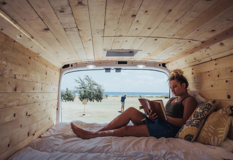 with impressive green mountains in the background.|Enjoying the view and a good book from a cozy RV rental. Wooden interior — photo 7