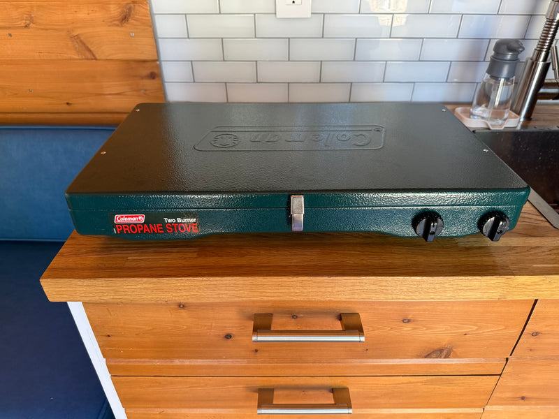 Portable Coleman Two Burner Propane Stove on wood cabinetry, great for RV rental cooking. — photo 17