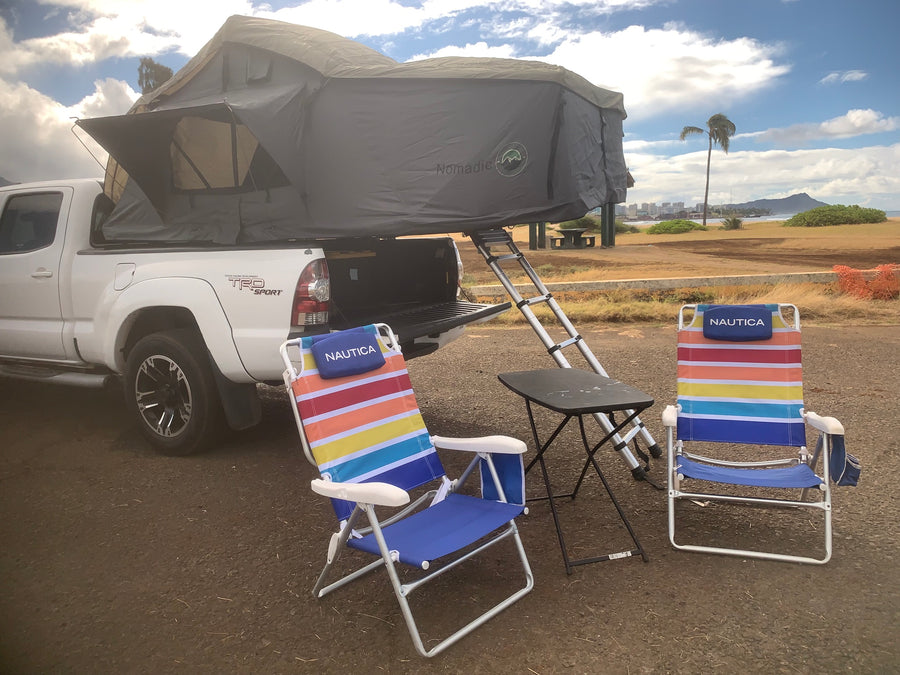 White Toyota pickup with a Nomadic rooftop tent
