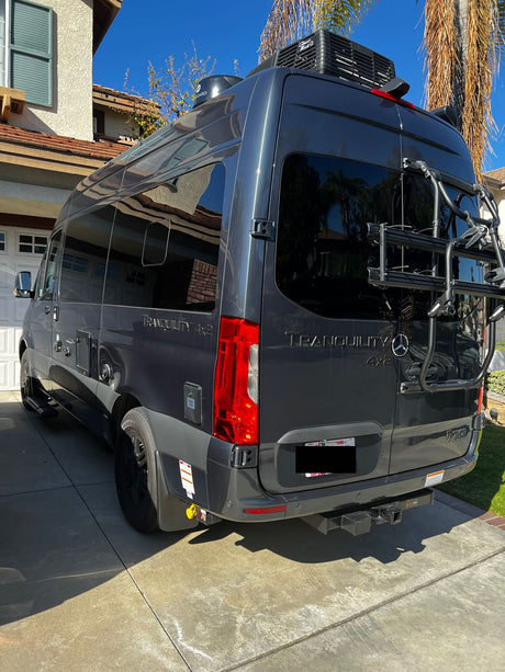 Dark gray Mercedes-Benz Sprinter camper van, ideal for rv rental, with bike rack & roof AC. Ready for adventure!