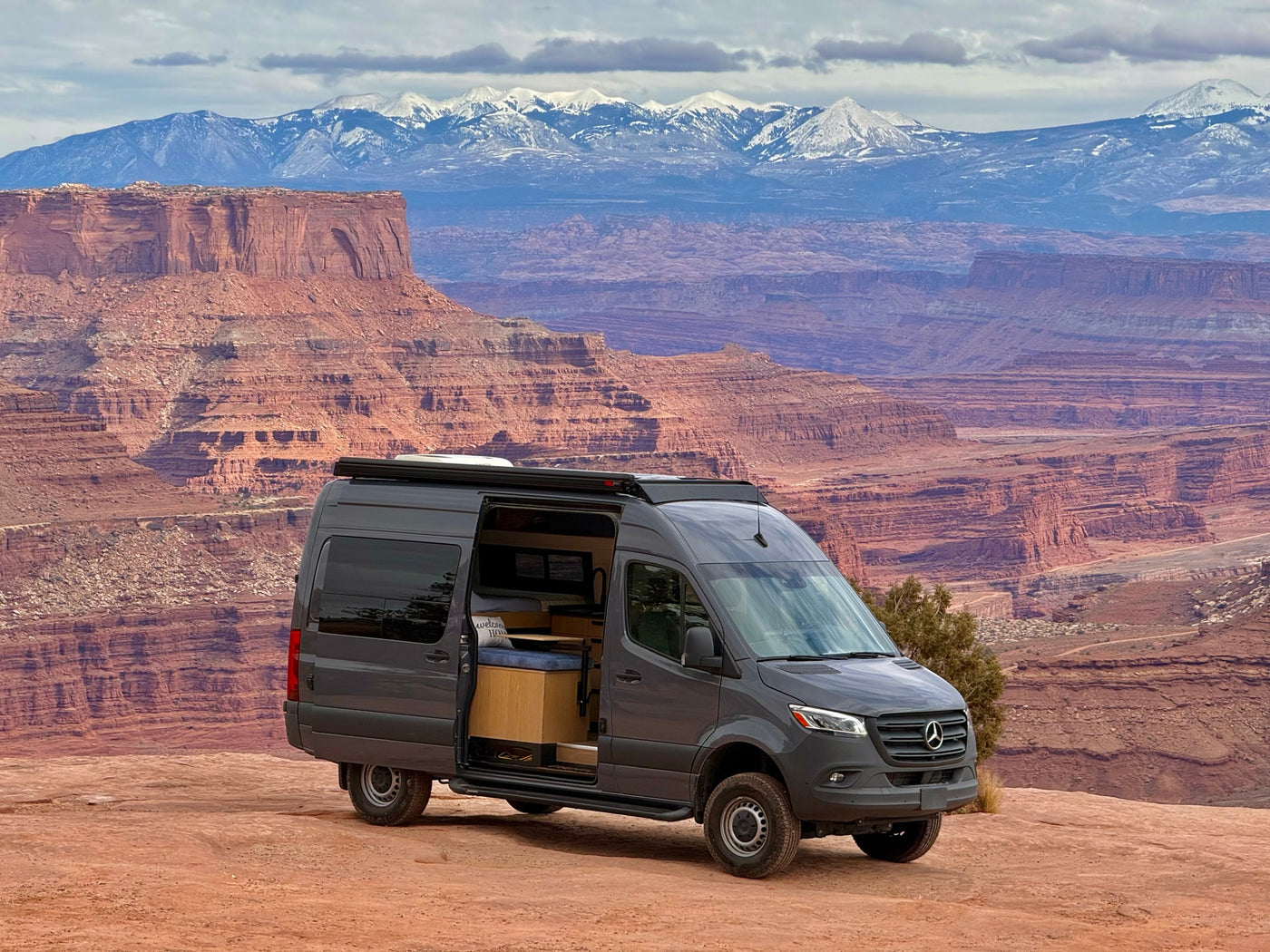 Adventure-ready Mercedes Sprinter camper van, ideal for rv rental trips, overlooking stunning red rock canyons and snowy mountains. — photo 4