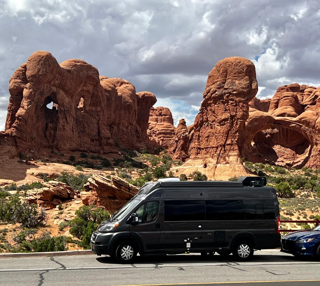  showcasing a scenic desert backdrop with red rock formations. Ideal for outdoor adventures.|Exploring desert trails! An RV rental with bikes ready for adventure — photo 10