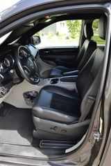 Spacious minivan interior, driver's view with steering wheel & black leather seats. Perfect for family travel or an RV rental journey.