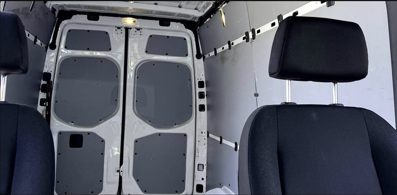 Rear cargo area & front seats of a clean van, ideal for RV rental conversions or transport. — photo 8