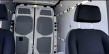 Rear cargo area & front seats of a clean van, ideal for RV rental conversions or transport.