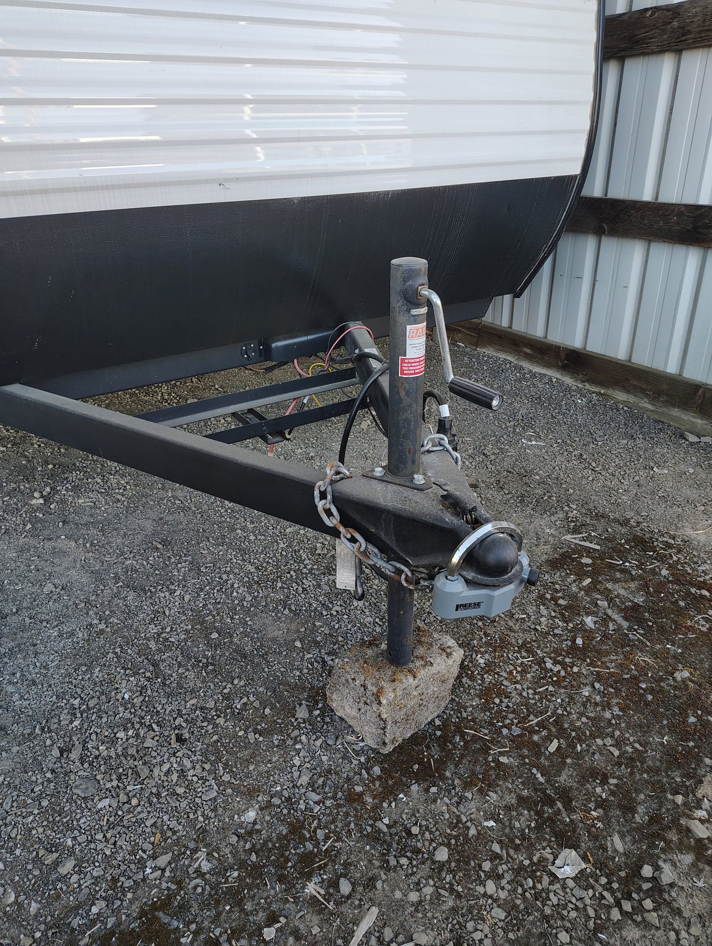  is parked on gravel in a storage shed with its door open.|A Coleman RV rental — photo 4