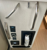 Inside an RV rental: grab handles, GFI outlet, battery switch, solar controller, and fire extinguisher.