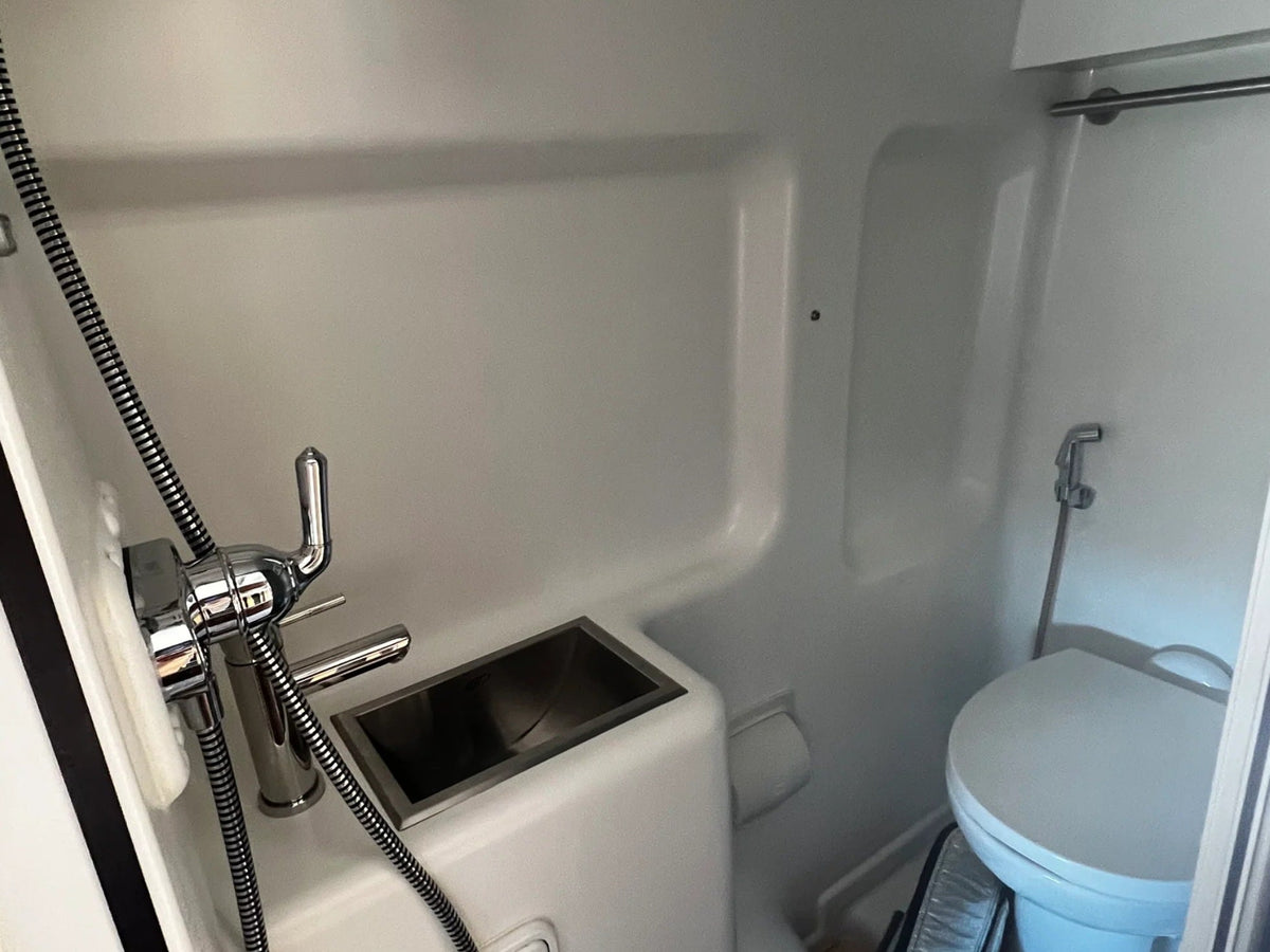  and dining space.|Explore this functional RV rental interior: bed — photo 7