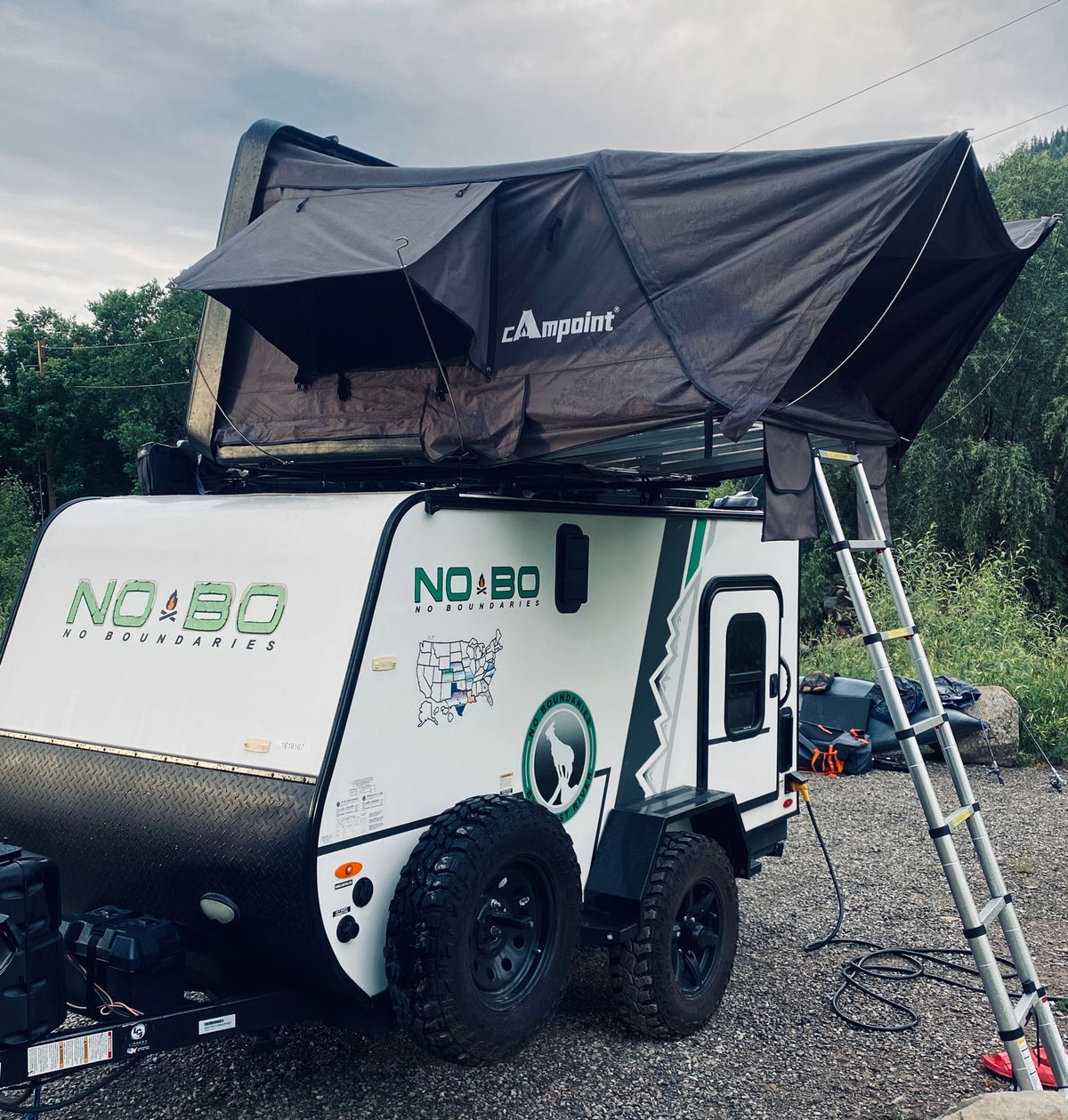 Adventure-ready RV rental: A NO BO travel trailer with a deployed Campoint rooftop tent