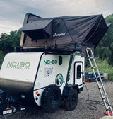 Adventure-ready RV rental: A NO BO travel trailer with a deployed Campoint rooftop tent, perfect for off-grid camping.