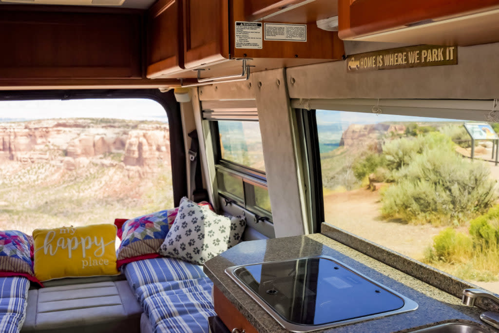  explores a desert dirt road. Ideal for scenic off-road adventures and memorable road trips.|Compact RV rental kitchen features a sink — photo 16