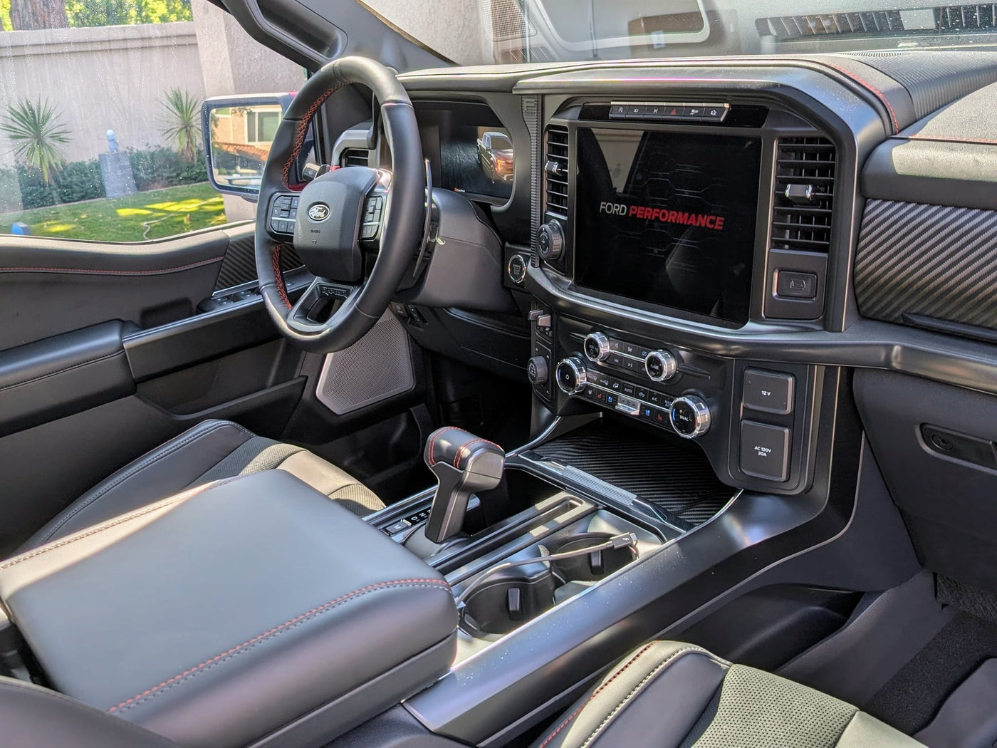  parked outdoors. Your next overlanding or RV rental adventure awaits!|High-performance Ford Raptor interior with red stitching — photo 2