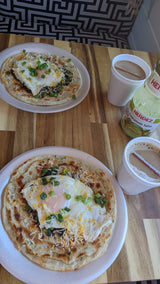 Hearty breakfast for an RV rental journey: fried eggs on flatbread with cheese, green onions, coffee, and guacamole salsa.